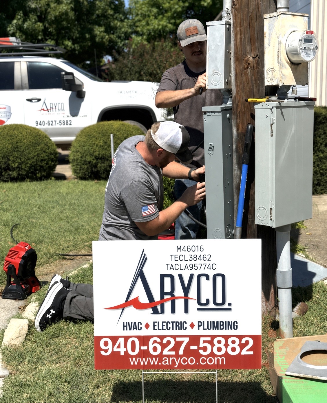 AryCo electricians replacing breakers in an outdoor service panel